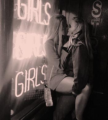 Girls kissing at female members only sex club