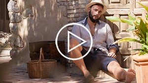 man sitting down outside dressed masturbating